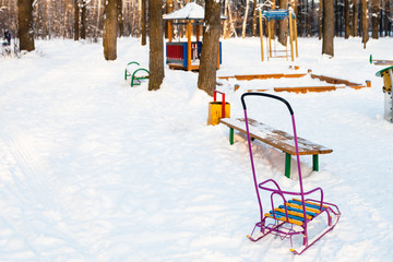 Poster - snow-covered playground in urban park in winter