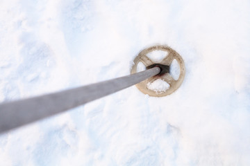 Wall Mural - top view of the old ski pole in snowy field