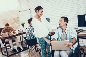 Wall Mural - Woman near Man on Wheelchair with Tablet in Office