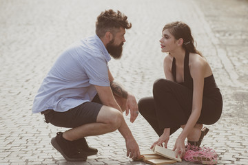 Wall Mural - Love at first sight. Man and woman falling in love. Bearded man and cute woman met on street. Hipster helping and looking at pretty girl. Couple in love on summer day. Enjoy romantic date and dating