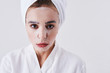 © Yakobchuk Olena - Young lady with purifying mask on her face standing against white background