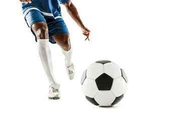 The legs of soccer player close-up isolated on white. African american model in action or movement with ball. The football, game, sport, player, athlete, competition concept