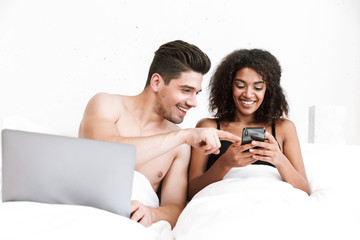 Wall Mural - Beautiful happy young multiethnic couple relaxing