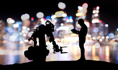 Wall Mural - Industry 4.0 technology , artificial intelligence trend concept. Silhouette of engineer man control to heavy automation robot arm machine. Bokeh flare light effect with building background.