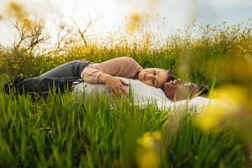 Wall Mural - young couple lying in meadow