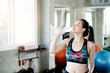 © Rapeepat - Portrait Asian women wearing exercise sportswear in the gym Hands holding a clean water bottle Drinking in the mouth to reduce the heat release that exercise and waste energy. Concept Health insurance