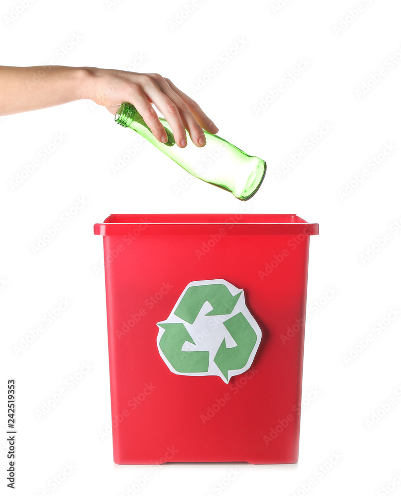 Female hand throwing garbage into trash bin on white background. Recycling concept