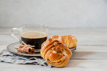 Wall Mural - Breakfast: cinnamon buns with a cup of coffee.