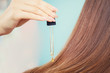 © Parilov - Pipette with oil to restore and protect long hair client girl