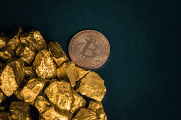 Closeup of bitcoin digital currency and gold nugget or gold ore on black background, precious stone or lump of golden stone, Cryptocurrency money financial and business concept.