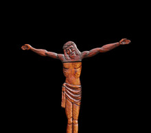 Fragment Of Wooden Antique Statue Of Crucified Jesus Christ Isolated On Black Background.