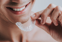 Close Up Of Smiling Man Holding Transparent Mouth Guard
