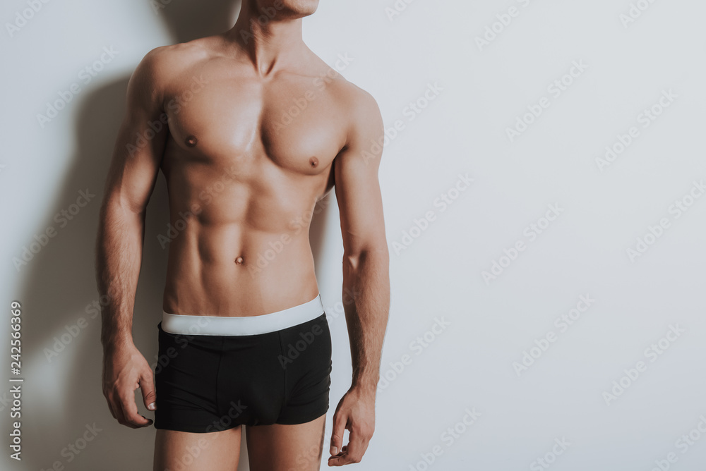 Young shirtless athletic man standing in black underwear - obrazy, fototapety, plakaty 