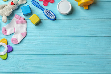 Wall Mural - flat lay composition with baby accessories and toys on color wooden background. space for text