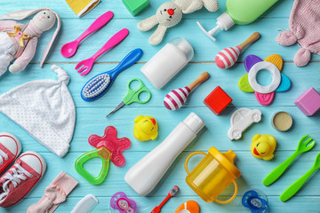 Wall Mural - flat lay composition with baby accessories and toys on color wooden background