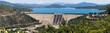 Panoramic view of Shasta Dam on a sunny day, Shasta mountain visible in the background; Northern California
