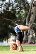© Peruphotoart - Young girl standing on her head doing yoga in the park