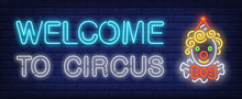 Welcome To Circus Neon Text With Funny Clown Head. Circus Performance Advertisement Design. Night Bright Neon Sign, Colorful Billboard, Light Banner. Vector Illustration In Neon Style.