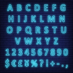 Wall Mural - Blue neon English alphabet, digits and signs on brick wall. Characters set. Night bright neon sign, colorful billboard, light banner. Vector illustration in neon style.