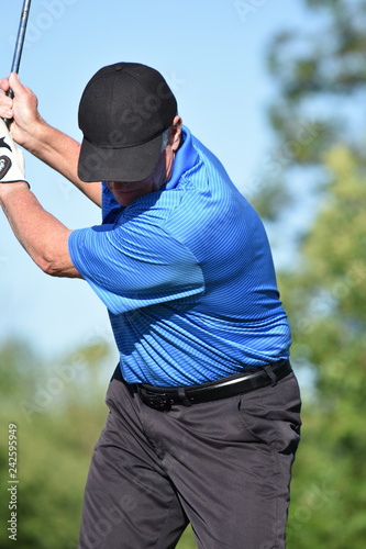 Fotografia, Obraz Fit Senior Male Golfer Exercising With Golf Club Swinging