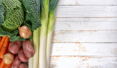 vegetables for french pot au feu on white wooden table