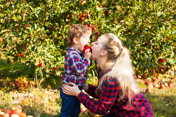 Wall Mural - Mother and daughter are bite an apple