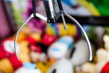 Closeup Shot Of Slot Machine Toy Crane In Amusement Park. Electronic Arcade Claw Gripper Game For Grabbing Stuffed As A Prize. Bokeh Effect Ideas In Photo