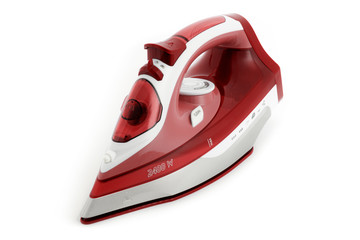 Steam iron laid on white background, red cordless type