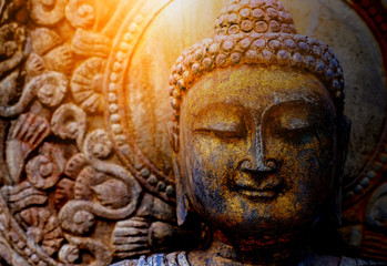 Rock Buddha statue with sunlight used for amulets of Buddhism religion. Buddhism is popular region in China Japan and south east Asia.copy space concept.