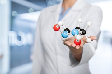 Wall Mural - Close up of Molecular structure model in hand on background