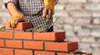 © BillionPhotos.com - Worker builds a brick wall in the house