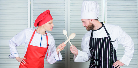 Ultimate cooking challenge. Culinary battle of two chefs. Couple compete in culinary arts. Kitchen rules. Culinary battle concept. Woman and bearded man culinary show competitors. Who cook better