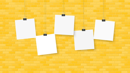 Wall Mural - Posters on binder clips. Paper templates on brick wall. Realistic mock up. Empty notepad sheet for your business design. Brick wall. Vector templates for lettering, quote, images or logos.