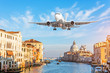 © aapsky - View on Grand canal and airplane flying in the sky. Italy travel concept