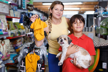 Woman with   son buying dog clothes