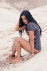 Beautiful athletic sensual woman on sand