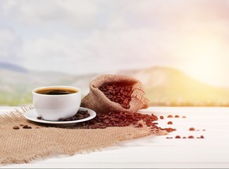 Canvas Print - Cup of hot coffee with beans on background