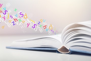Wall Mural - open book on old wooden table.
