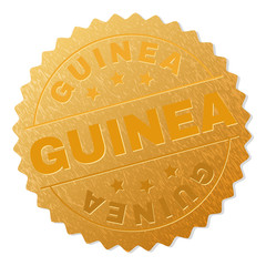 GUINEA gold stamp award. Vector gold award with GUINEA caption. Text labels are placed between parallel lines and on circle. Golden surface has metallic effect.