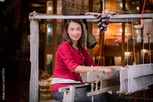 Fotografie, Obraz Women are weaving with ancient weaving machines