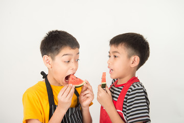 Wall Mural - Little boys eat watermelon on white