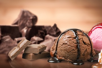 Wall Mural - Broken chocolate bar and ice cream scoop on background