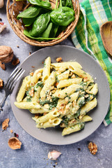 Wall Mural - Penne pasta with spinach, gorgonzola cheese and walnuts