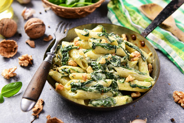 Wall Mural - Penne pasta with spinach, gorgonzola cheese and walnuts