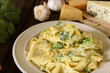 Tagliatelle pasta with cheese sauce and broccoli