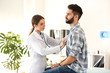 © Pixel-Shot - Female doctor working with male patient in clinic