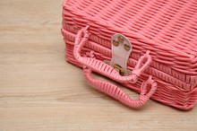 A Pink Basket On A Wooden Background