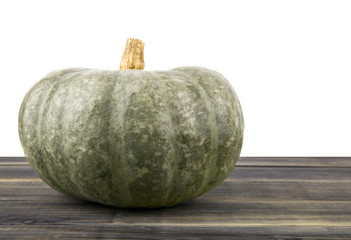 Wall Mural - raw pumpkin on wooden table isolated on white background