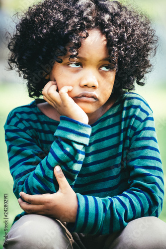 Unhappy Bored Little African American Kid Sitting In The
