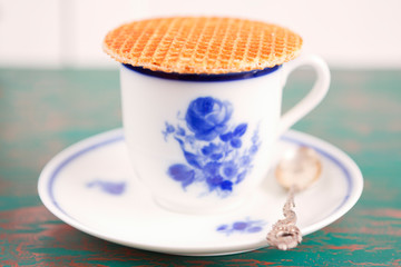 Wall Mural - Cup of coffee with a Dutch stroopwafel cookie